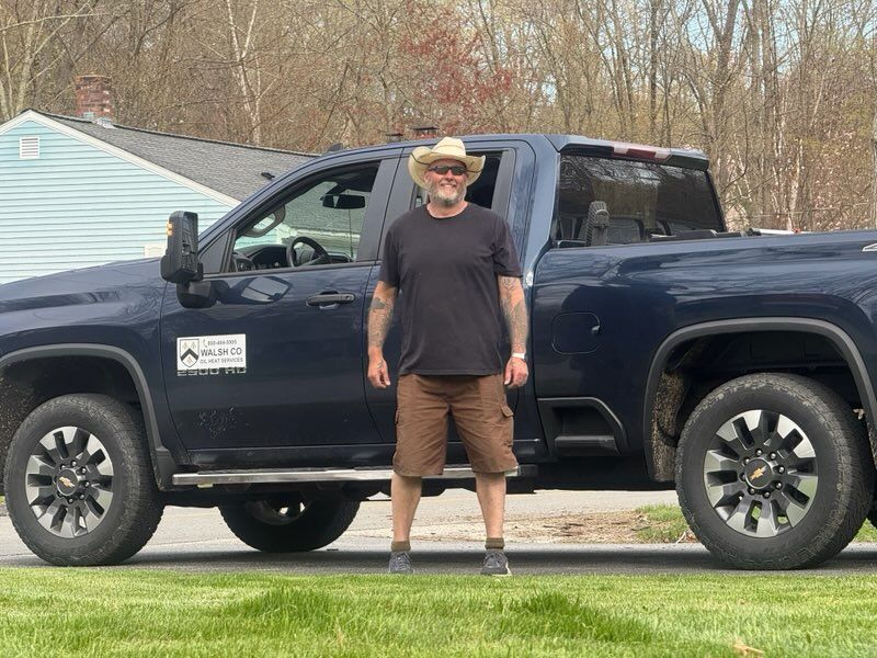 A WalshCo team member beside the company work truck